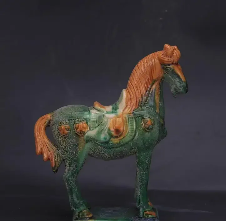 Antique collection and decoration: Tricolor-glazed pottery statue of a horse with green overglaze from the Tang Dynasty