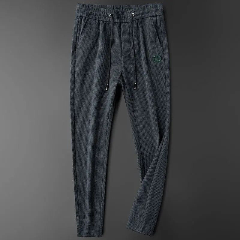 Pantalones delgados para hombre, pantalones deportivos informales con letras, pies de corbata ajustados, pantalones protectores de productos europeos de gama alta