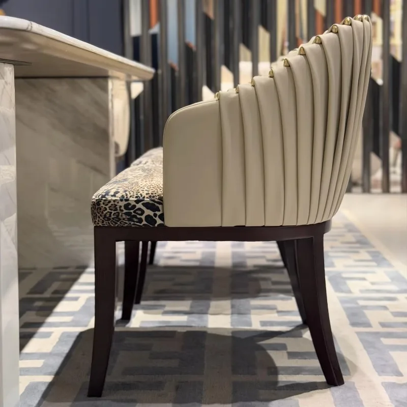 Leather and velvet dining chairs with brass studs, pleated backrests, upholstered seats, wooden legs, kitchen chairs