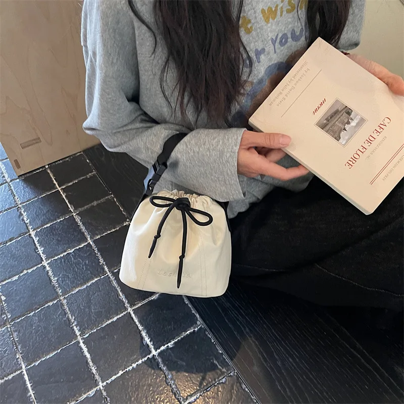 Women's Black Nylon Drawstring Bucket Bag with Adjustable Strap and Logo Detail Minimalist Crossbody Sling Purse for Daily view 4