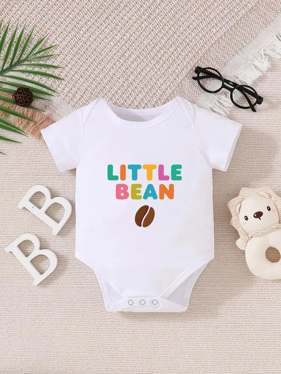 

Playful letter-printed baby short-sleeve triangle bodysuit. Button closure for easy dressing, machine washable