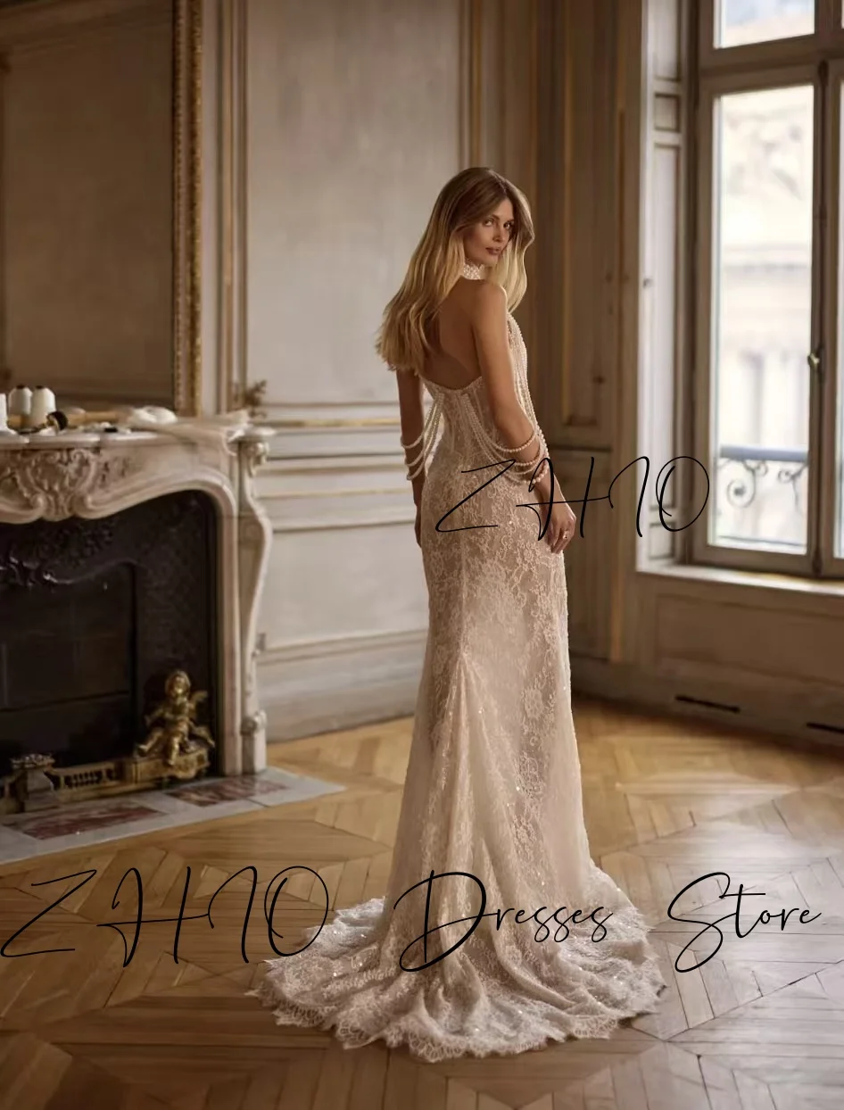 ชุดแต่งงานหรูหรา ZHIO ประดับมุก คอร์เซ็ทแบบผูกคอ ทรงเมอร์เมด ชายกระโปรงยาวลากพื้น สีไอวอรี่ ผ้าลูกไม้ ชุดราตรีเจ้าสาว สามารถสั่งตัดได้