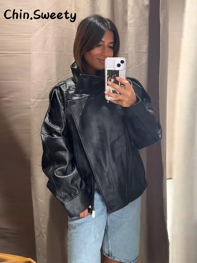 Damska kurtka skórzana z zamkiem błyskawicznym, czarna, z klapami, długim rękawem, kieszeniami, uniwersalna, elegancka odzież wierzchnia na jesień 2025, idealna do pracy.