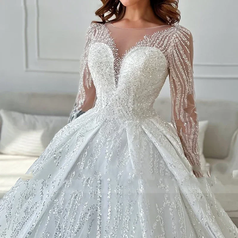 Lussuoso abito da sposa da donna bianco a trapezio in pizzo con perline 2026 Abito da sposa sexy con colletto trasparente a maniche lunghe personalizzato