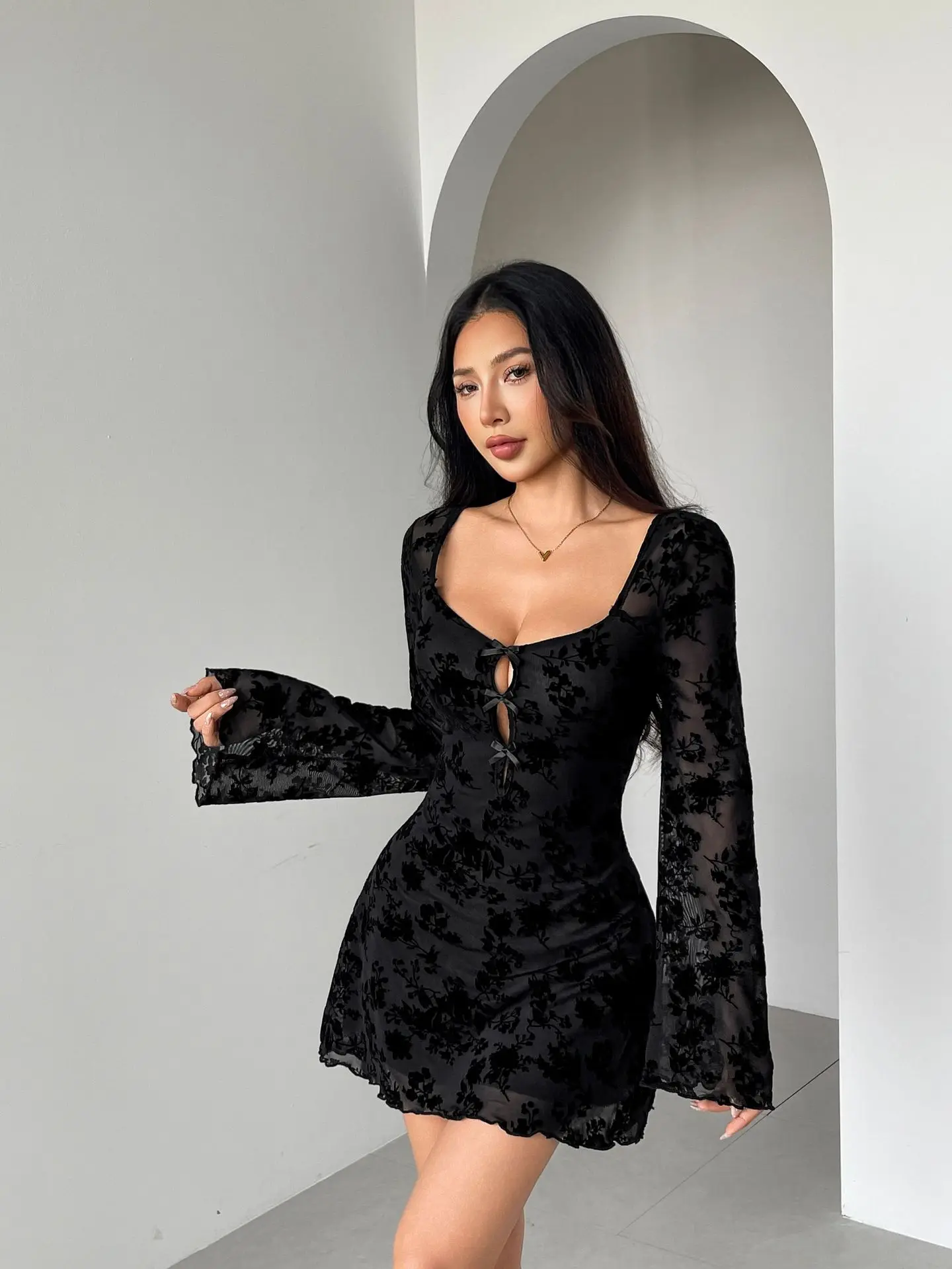 New autumn dress with long sleeves, featuring floral cutouts and bow details, suitable for women.