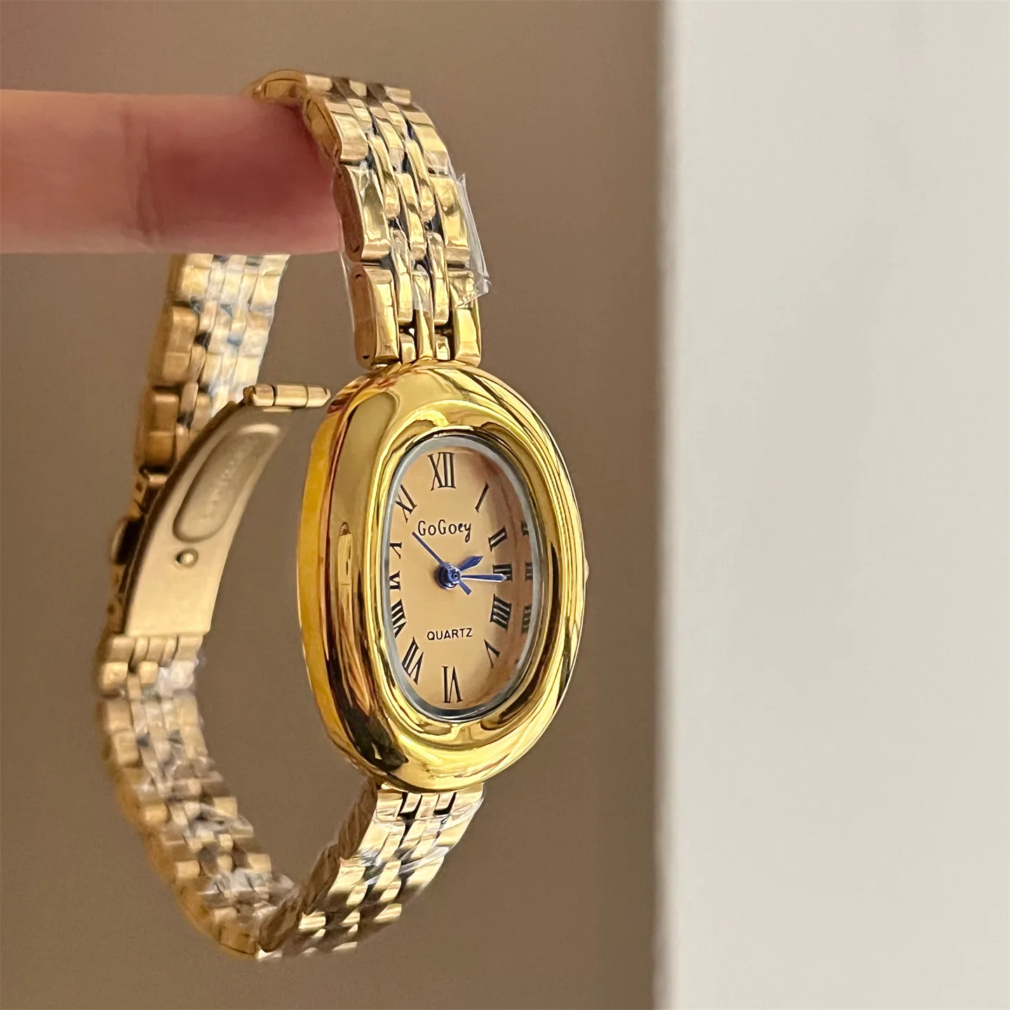 

Oval gold-tone vintage-style watch with a retro steel strap. A select collection of high-end watches and women's accessories.