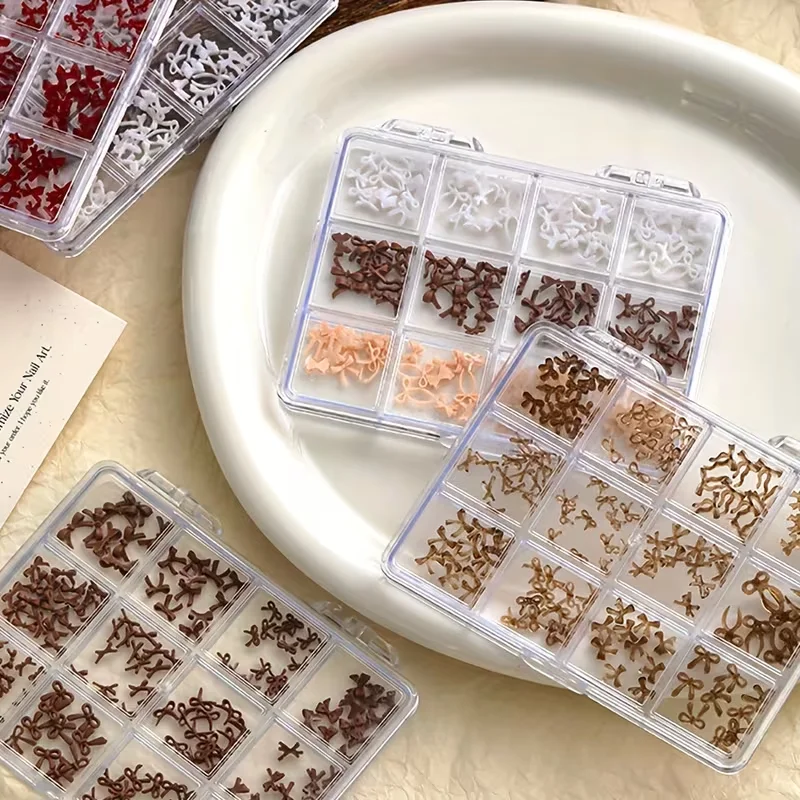 A box of 12 colorful, sweet bow nail art accessories, made of resin, perfect for DIY nail decorations.