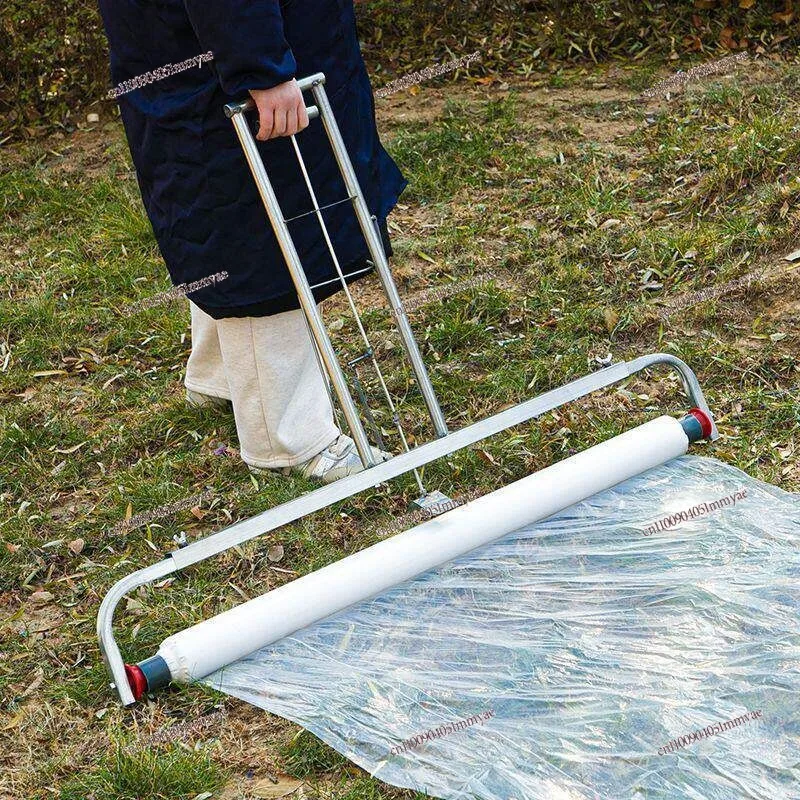 Hand-pulled film laying machine. Cover film agricultural use. Adjustable small accessory bracket.