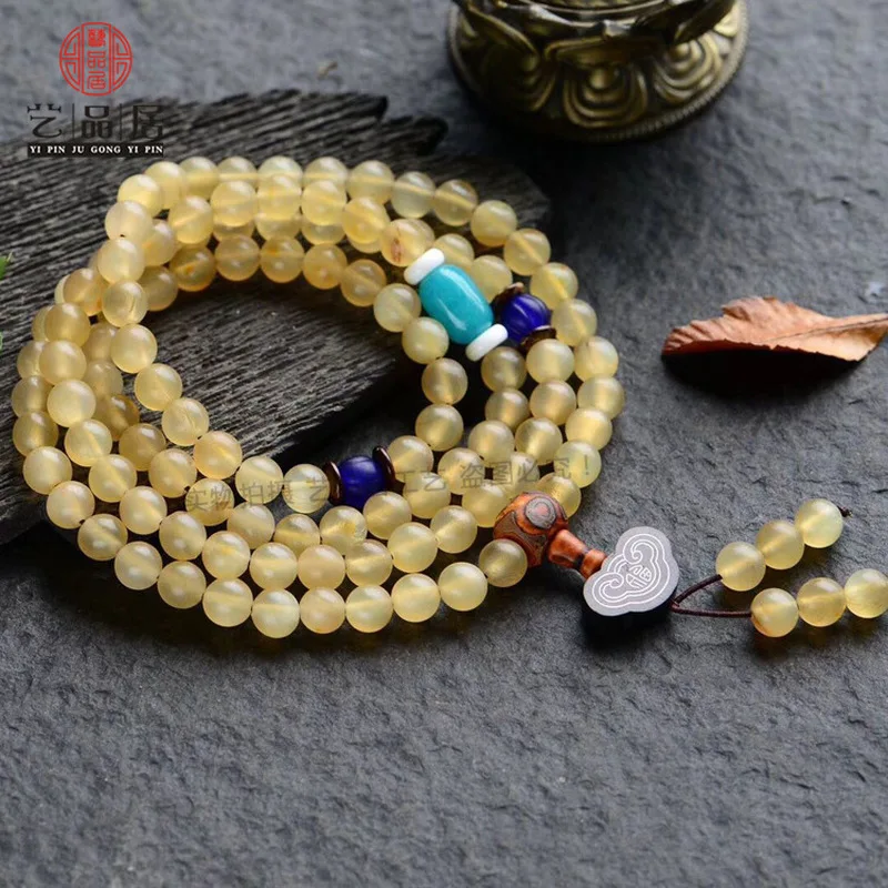 108 Round Bead Bracelet With Glass Beads And Sheep Horn Charms