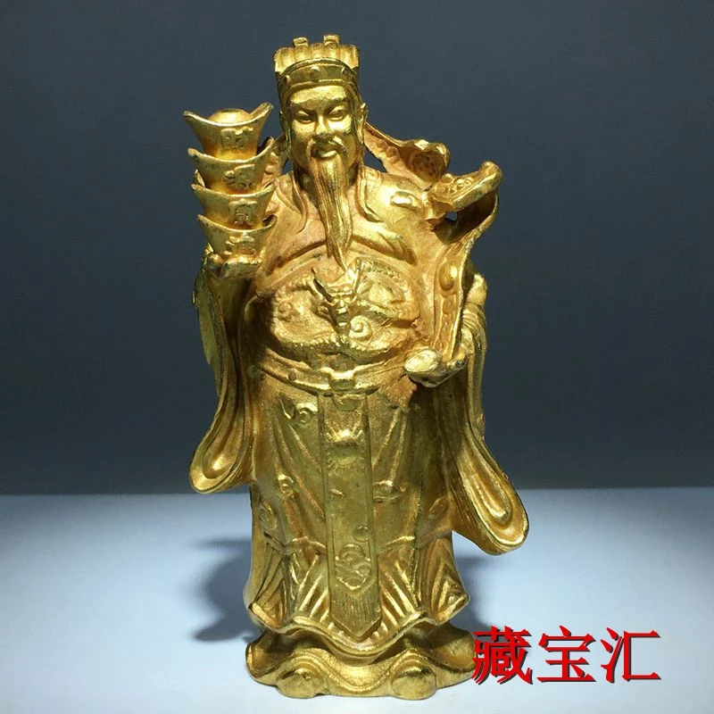 

gold-plated brass God Wealth makes a fortune financial resources are rolling standing like a bronze statue of Wealth to worship