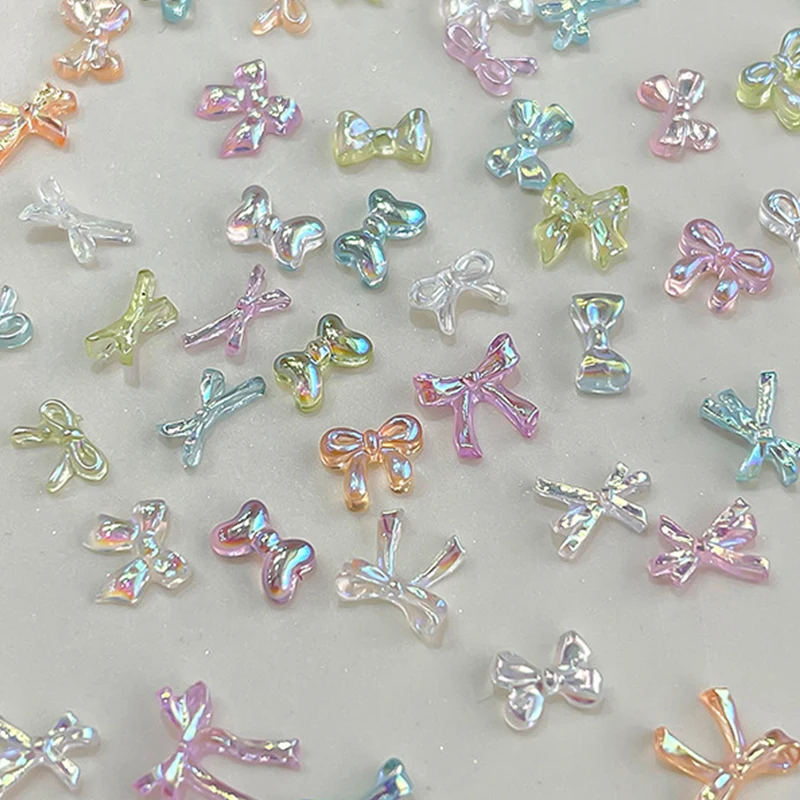 50 ชิ้นที่มีสีสันโบว์เล็บ Charms เล็บอุปกรณ์เสริมศิลปะภาพลวงตา AB สีเรซิ่นริบบิ้น Bows เล็บตกแต่ง Charm