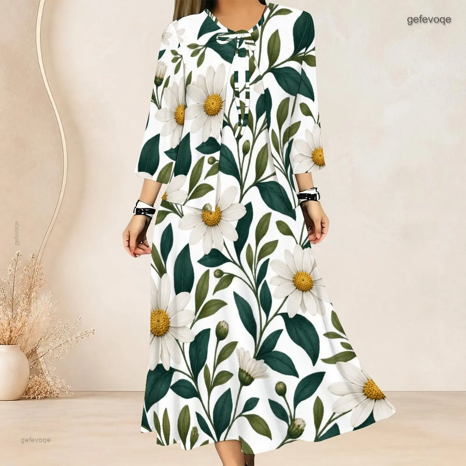 Conjunto de dos piezas para mujer: top corto con estampado de hojas verdes y margaritas, mangas 3/4 y cuello con lazo, y vestido largo.