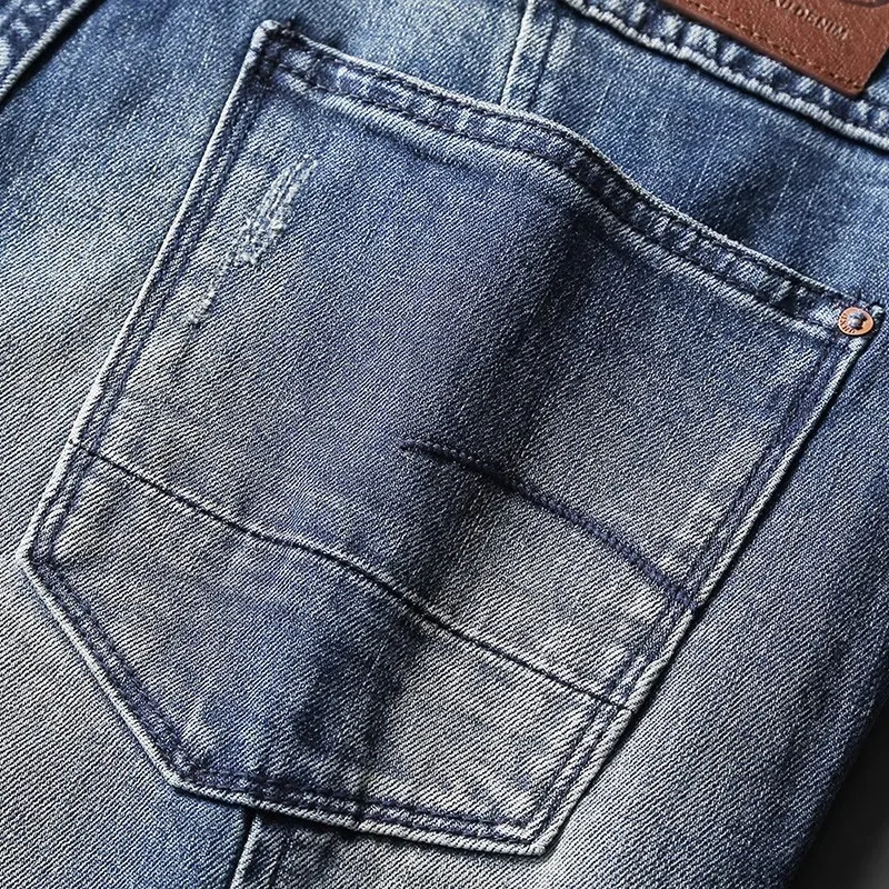 Jeans da uomo di alta moda di strada retrò lavati blu elasticizzati Slim Fit impiombati Jeans da motociclista firmati Homme pantaloni in Denim Hip Hop Patched