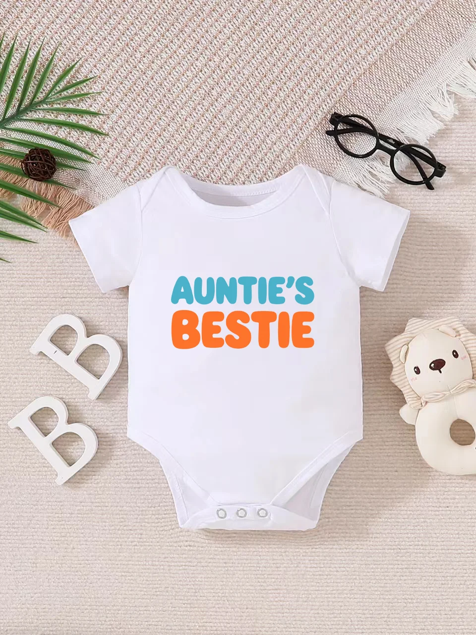 

Playful letter-printed baby short-sleeve triangle bodysuit. Button closure for easy dressing, machine washable