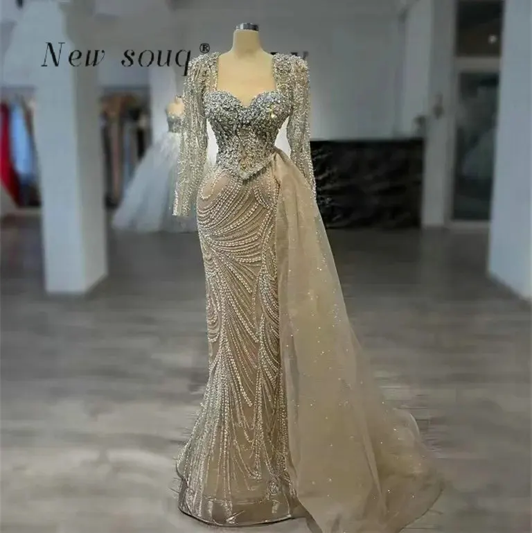 

Nude Champagne Long Sleeves Mermaid Evening Dresses with Side Train Customized Arabic Crystals Beaded Formal Gowns for Women