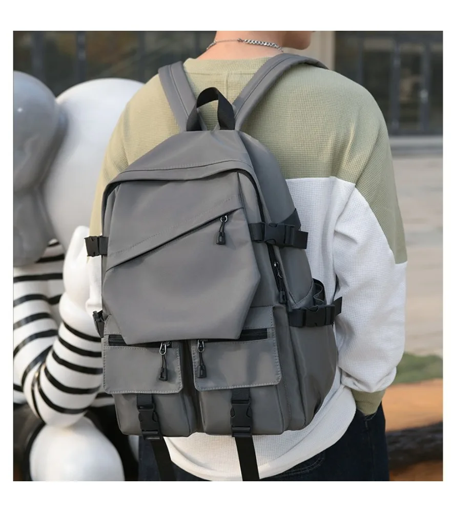 Black diagonal flap multi pocket backpack anti splash wear resistant fabric for daily short outdoor journeys