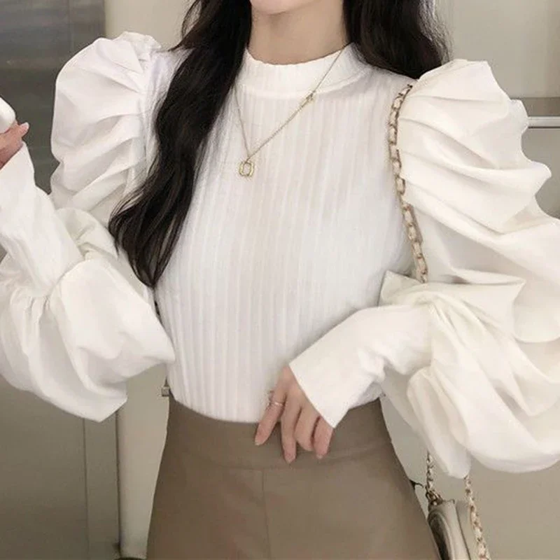 

Solid color lantern sleeve stitching white sweater women's new Korean version of slim fashion design sense niche bottoming top