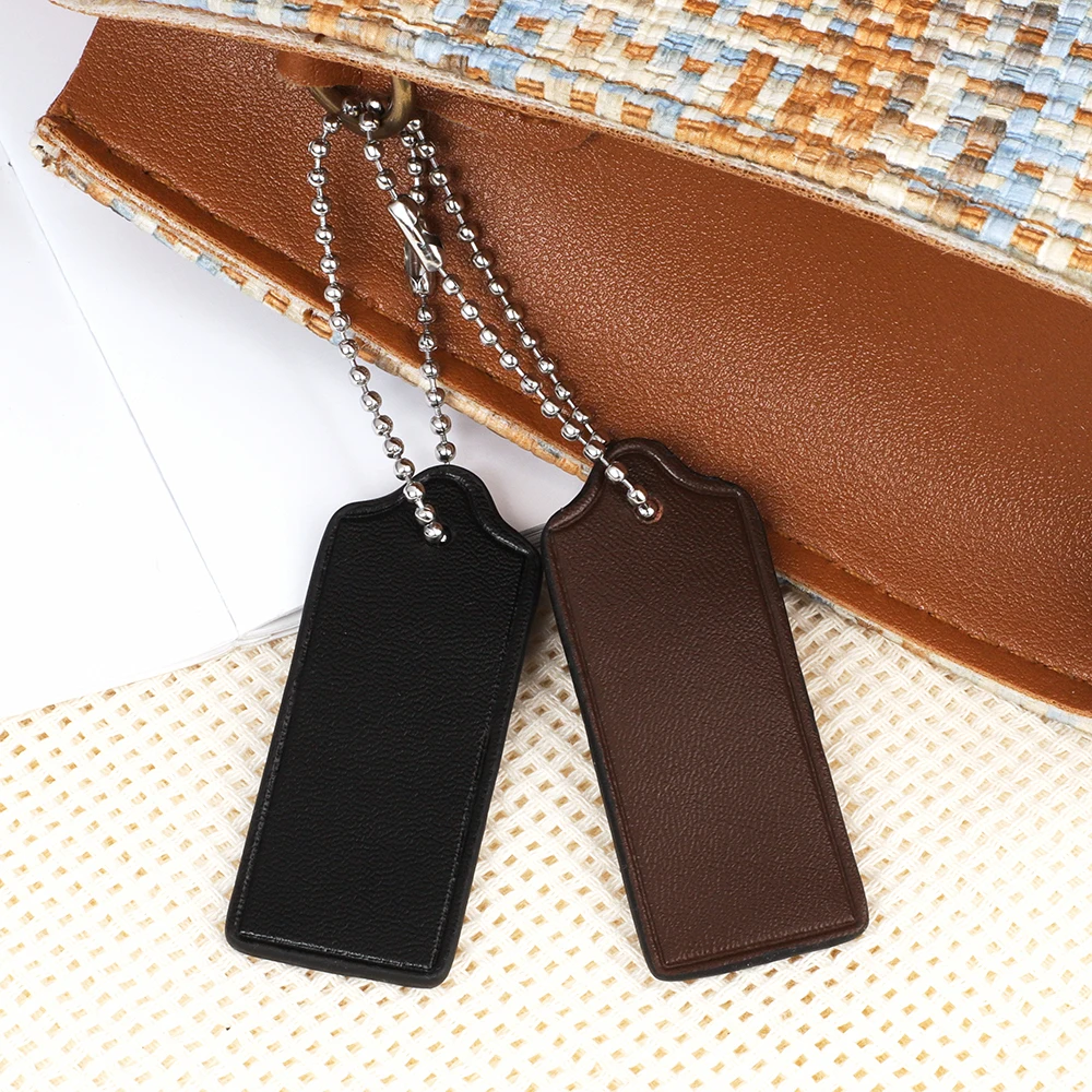 جلد البقر علامة الأمتعة حقيبة السفر العلامات أكياس الملحقات حقيبة جلدية حقيقية سحر سلسلة المفاتيح قلادة حقيبة يد محفظة شنق