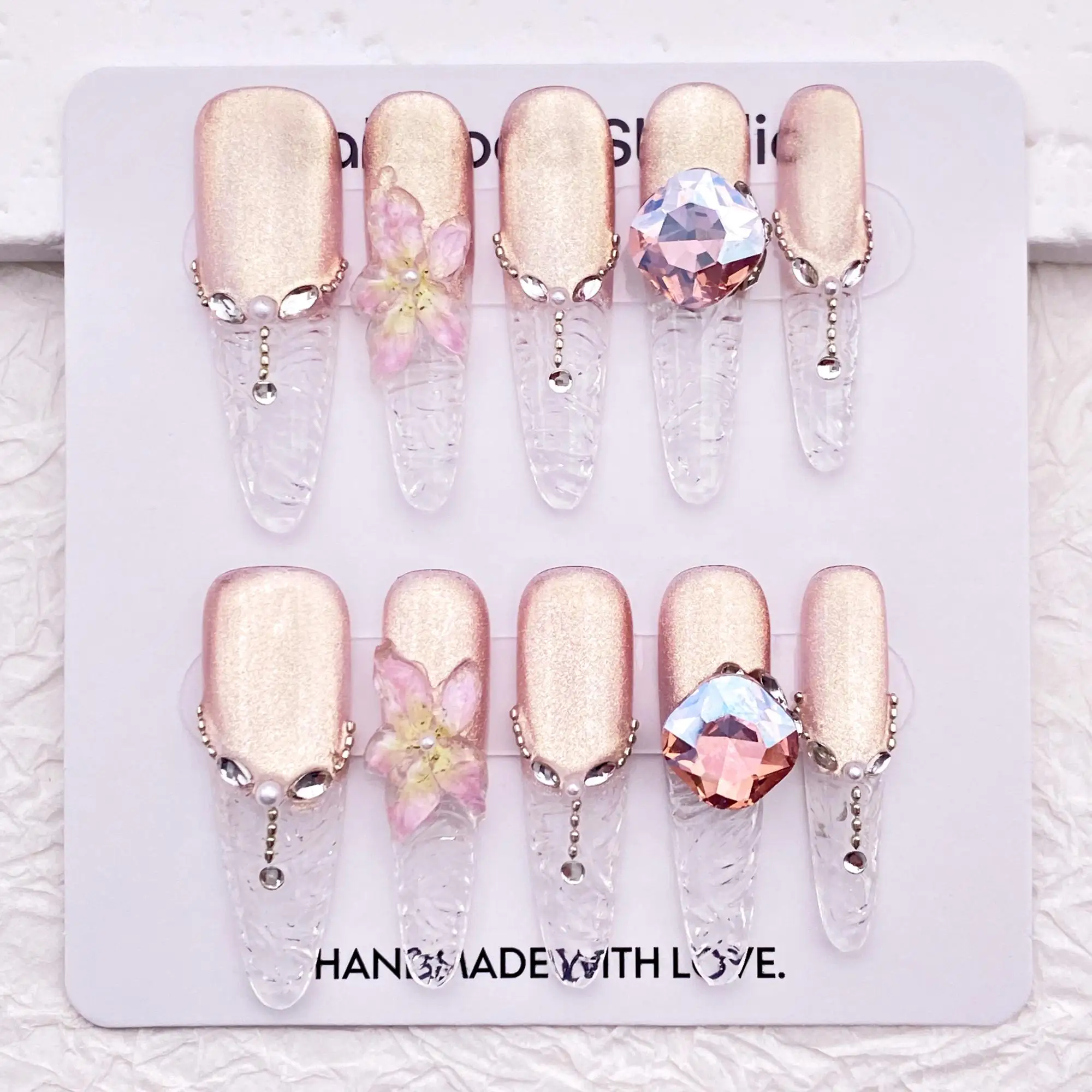 

Cute light pink cat eye manicure with sparkling rhinestones, elegant French tip manicure, reusable high-quality manicure
