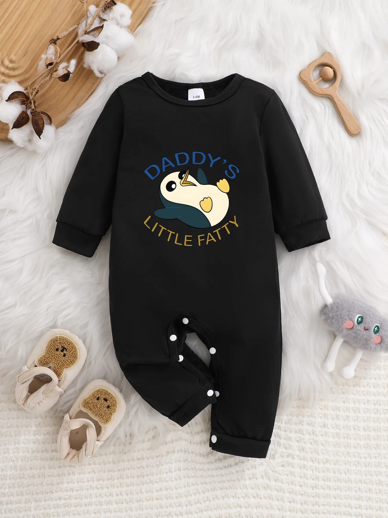 A baby long-sleeved onesie with interesting letter prints. It features a buttoned design for easy putting on and taking off