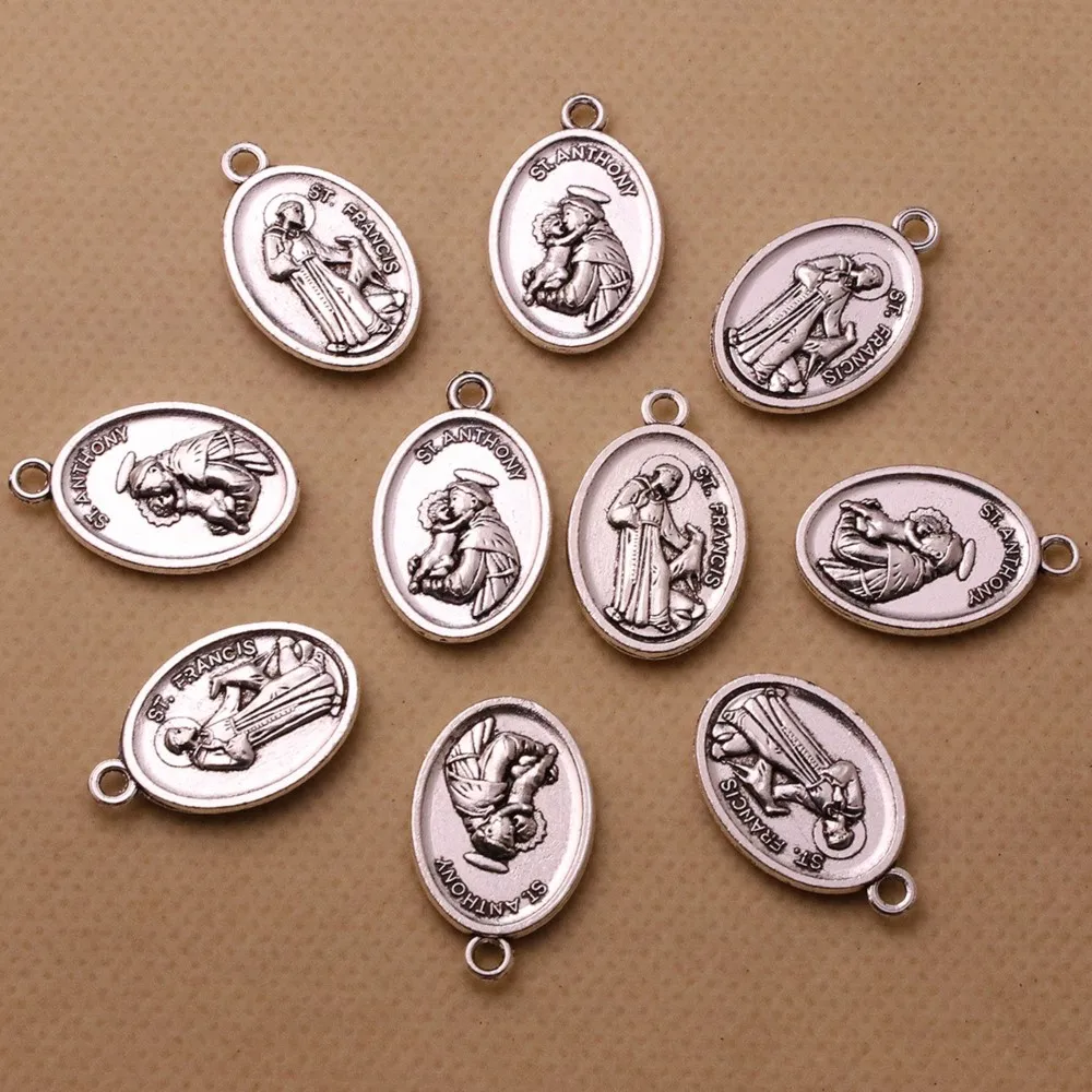 20 piezas de San Antonio que sostiene la medalla de Jesús infantil, colgantes de dijes de San Francisco con patrón cristiano para collar, accesorios de joyería DIY