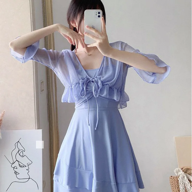 

Женский слитный купальник-платье светло-голубого цвета с V-образным вырезом, завязками спереди, прозрачной сетчатой накидкой и оборками по низу, летний пляжный купальник