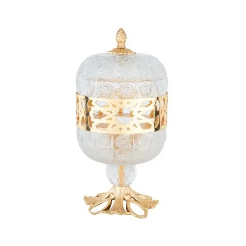 Golden brass incense burner with ornate lid and elegant pedestal base design engraved with crystal body