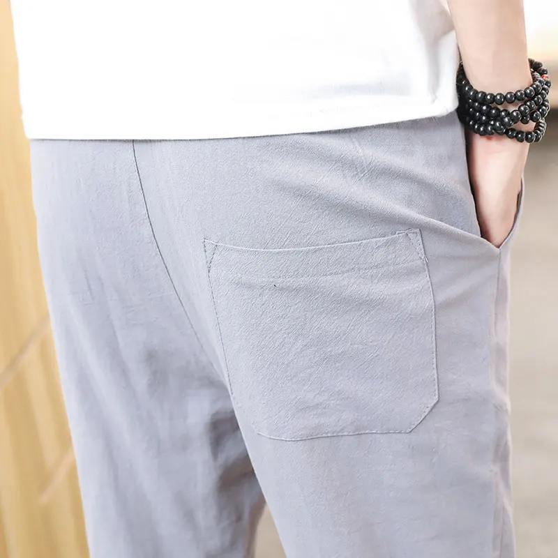 بنطلون رجالي صيفي من القطن والكتان بقصة ضيقة وخفيف الوزن بطول تسعة أرباع، بنمط الشباب الحيوي وخصر متوسط بلون واحد