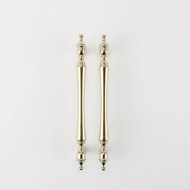 Pair of slim gold cabinet handles on a white background