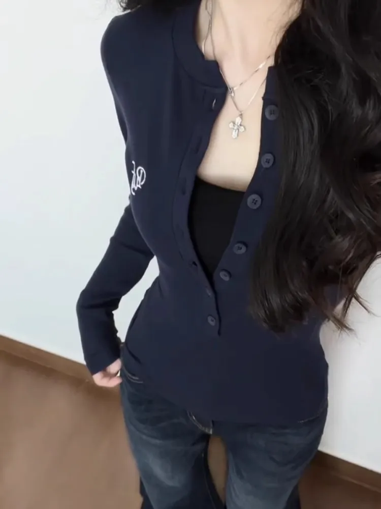 Korean style semi open button stand up collar embroidered long sleeved waist cinching top for slimming effect
