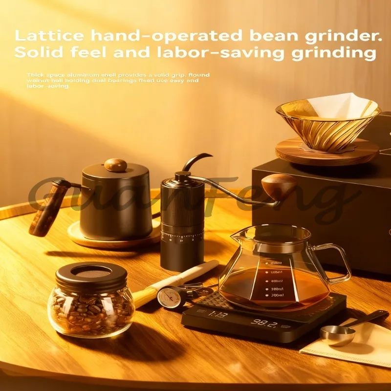 Outdoor hand-brewed coffee set with metallic glass poured over kettle and grinder