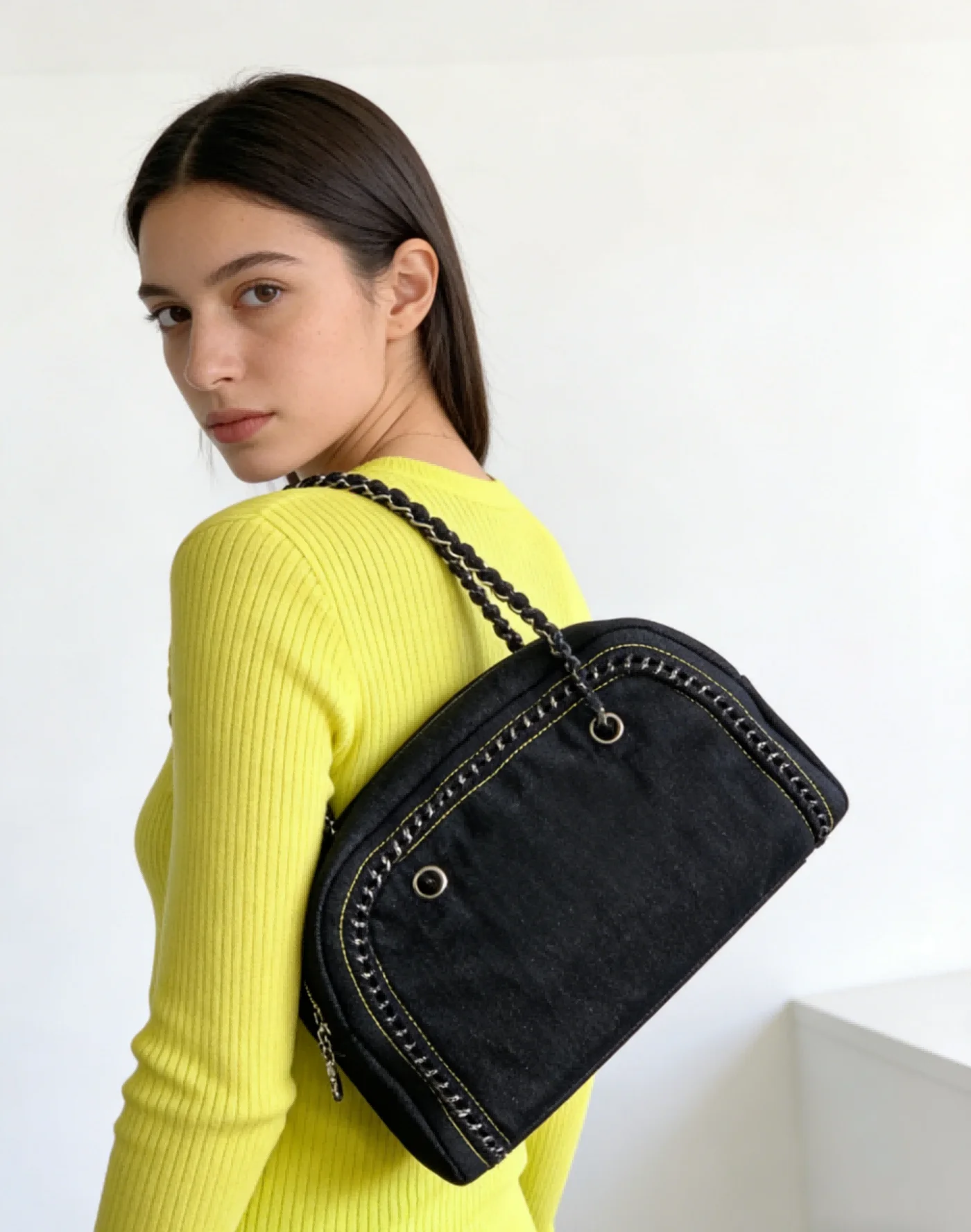 

Fashion Black Sling Bag for Women with Contrast Stitching Curved Silhouette and Braided Shoulder Strap Ideal