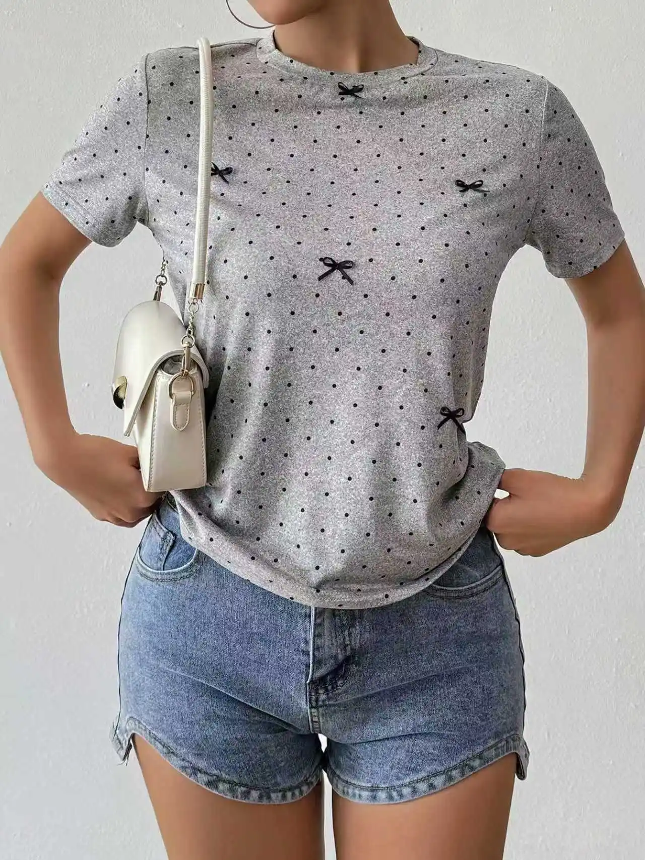 Ladies' round-neck short-sleeved top with polka dots and bow decoration for spring and summer.