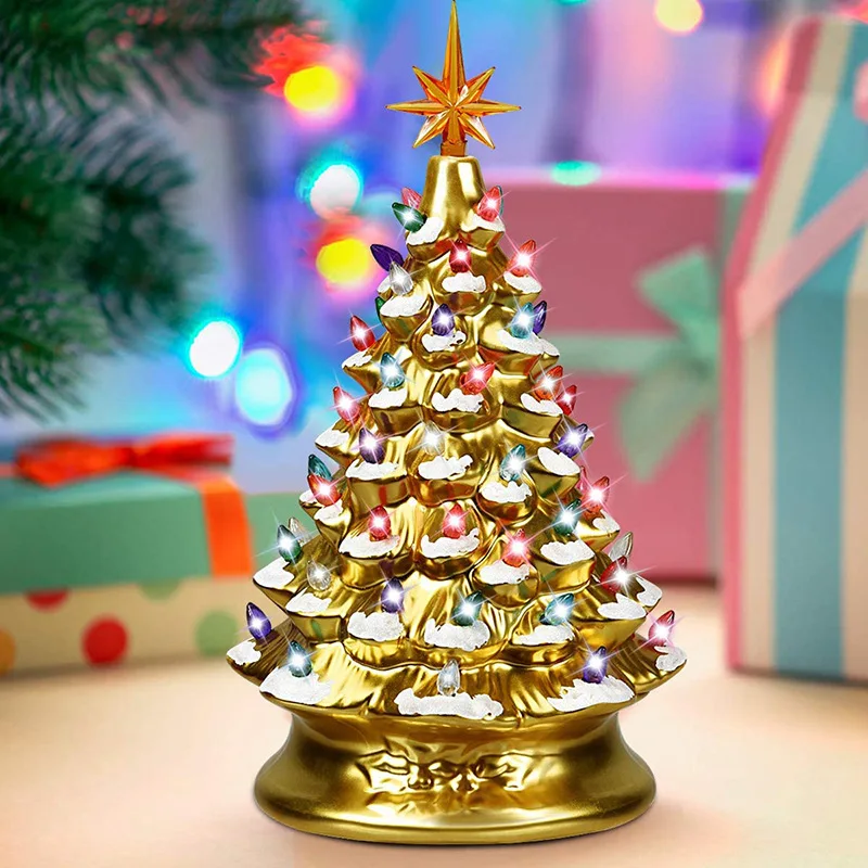 Golden and silver resin Christmas tree with snowflakes and glowing colored lights- a festive table