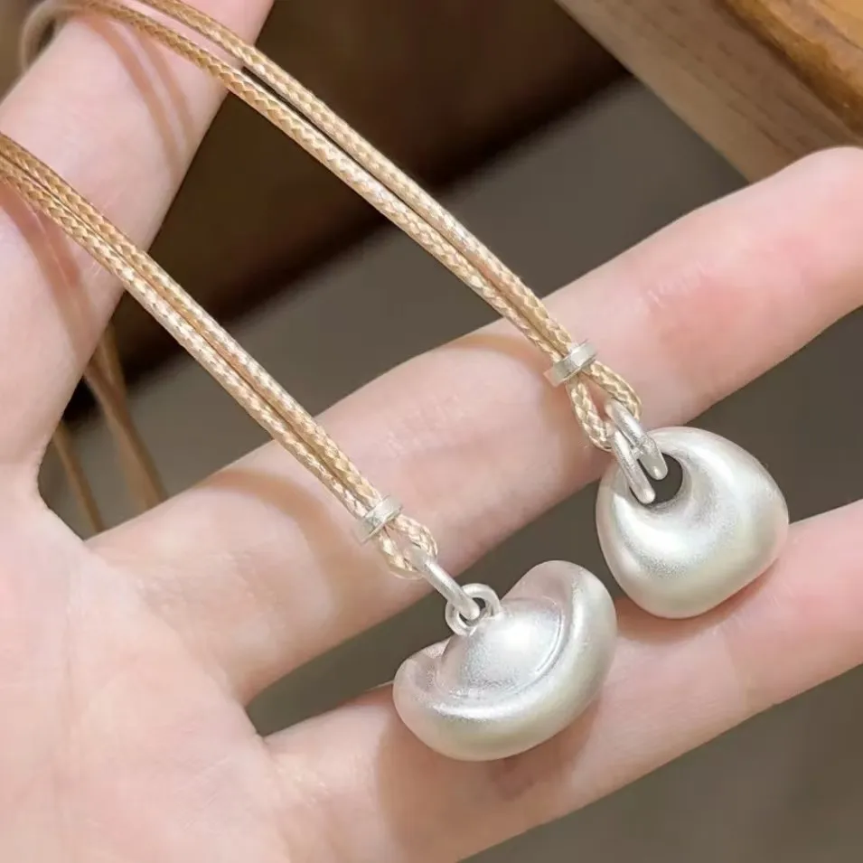 

Yuanbao Fortune Bag Solid ancient method silver tuotuo necklace, women's light luxury, niche and high-end long sweater chain pen