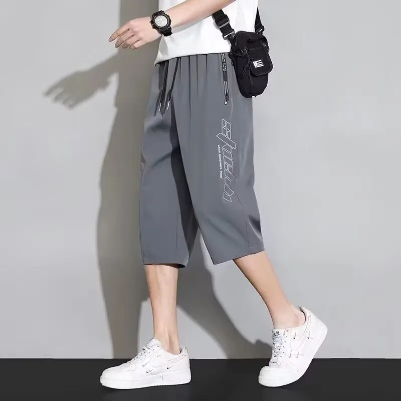 Men's loose quick drying thin five quarter casual shorts, summer vertical striped versatile trendy big slit pants