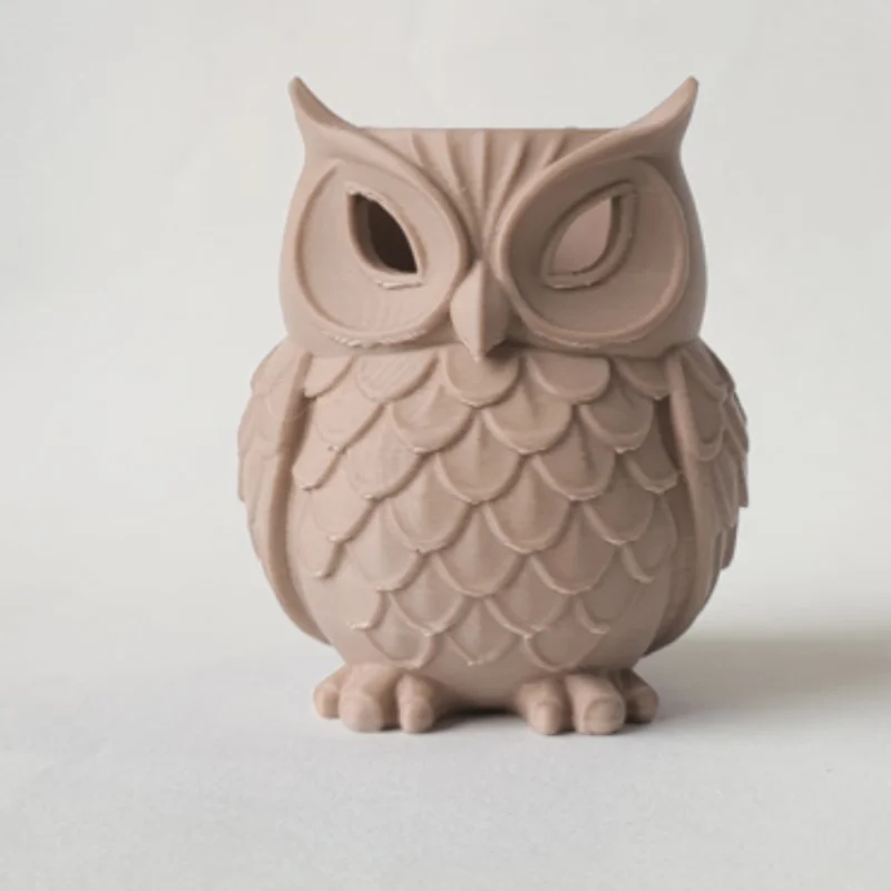 An owl statue, which can be used as a pen holder for the desk or as a decoration for the home
