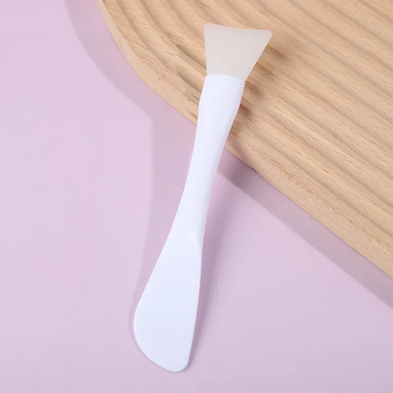 Dual-use silicone mud mask brush with built-in scraper