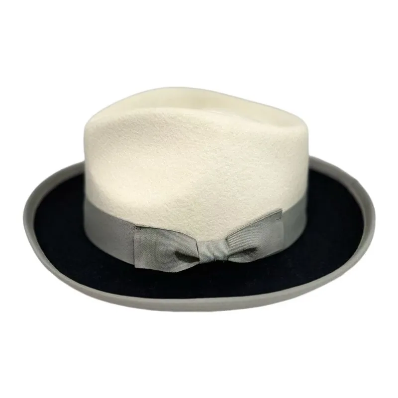 A white and black patchwork top hat with knot decoration felt