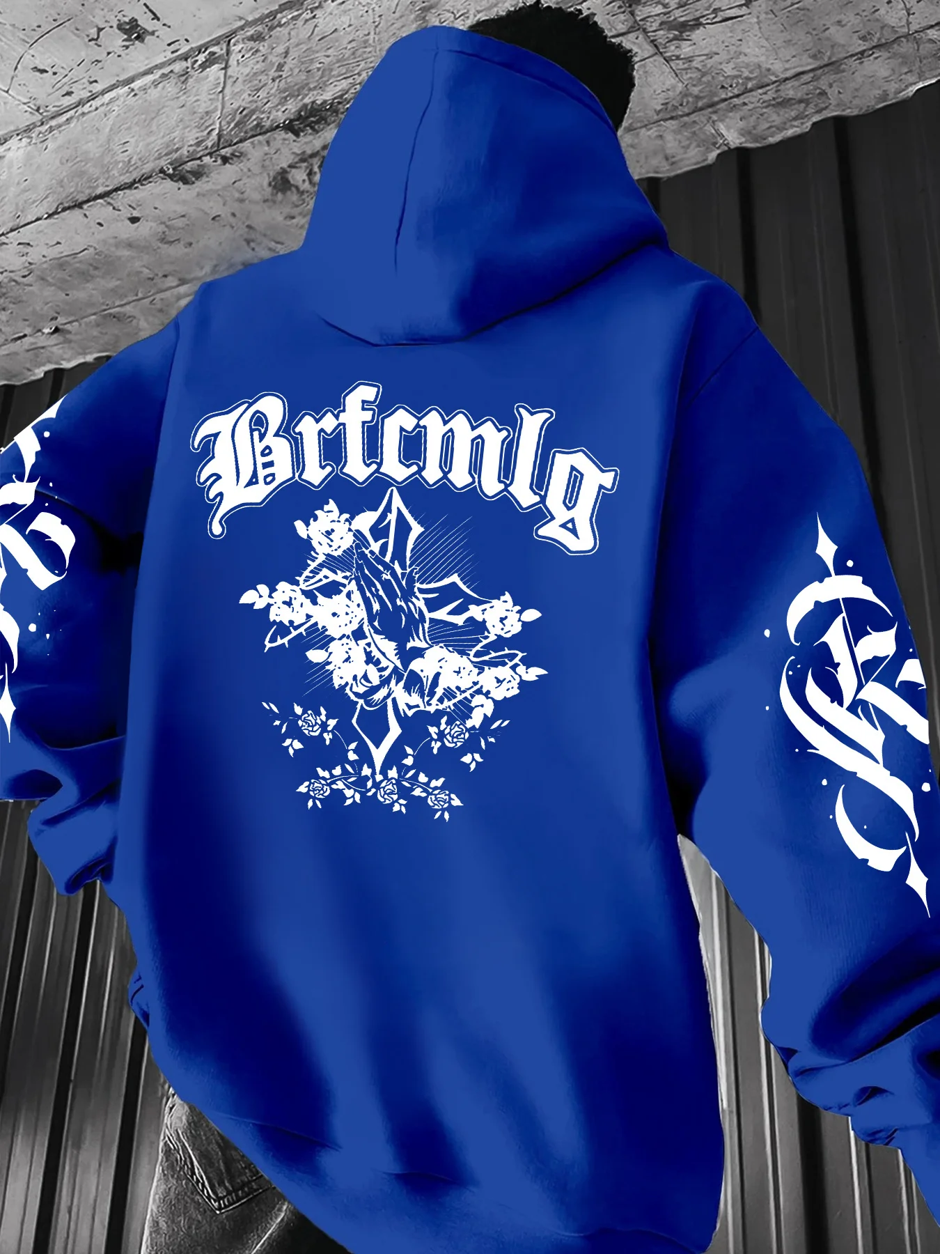 Street man's hooded sweatshirt with ornate gothic script prayer hands and rose print. Artistic design of a loose turtleneck top.