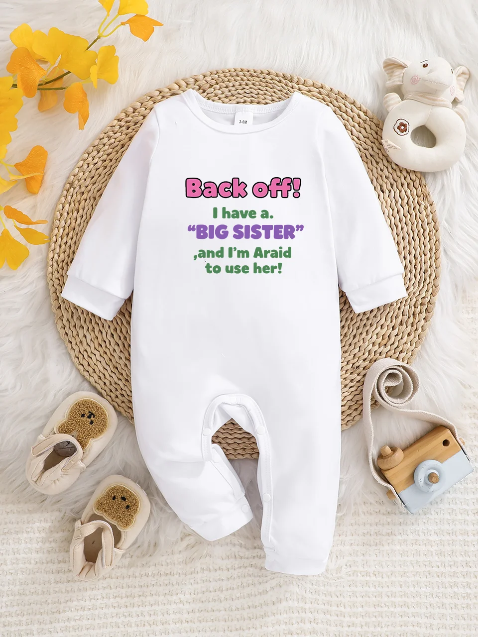 A baby long-sleeved onesie with interesting letter prints. It features a buttoned design for easy putting on and taking off