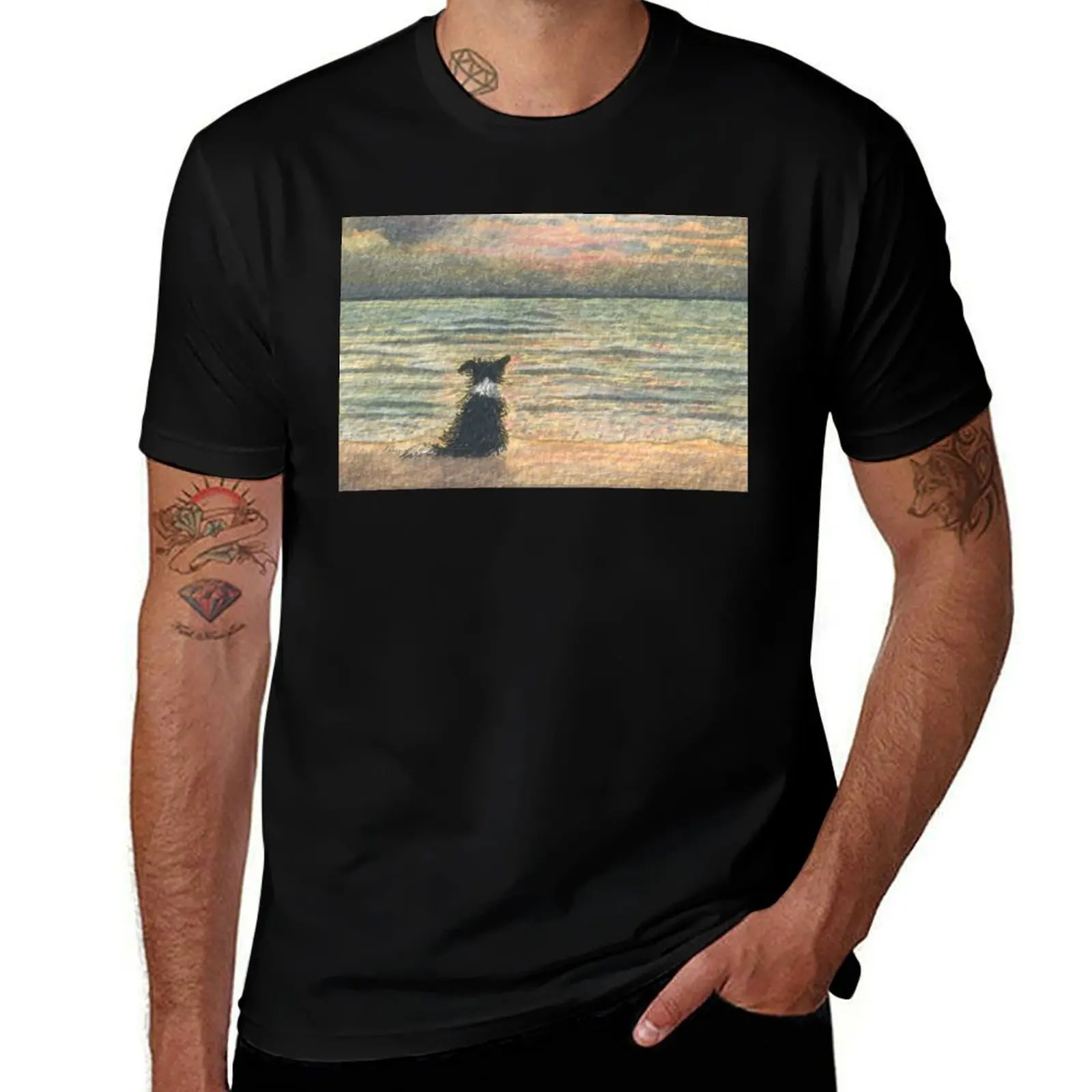 A Border collie dog gazes out over the ocean watching the sun come up, greeting the morning T-Shirt