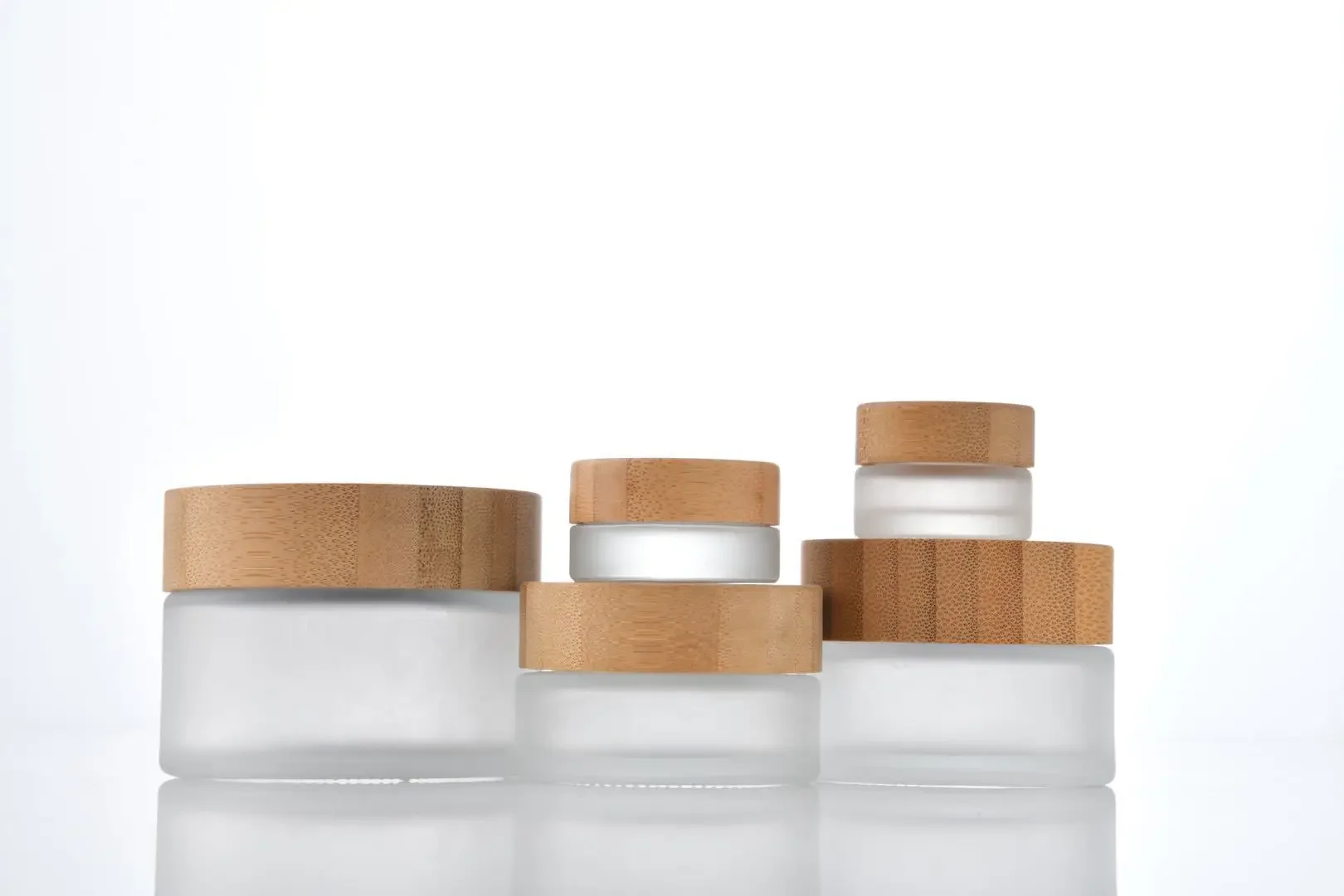 

Cosmetic Packaging Bottles Custom Logo clear frosted glass cream jars with for face cream/eye creamnatural Bamboo and Wood Cap