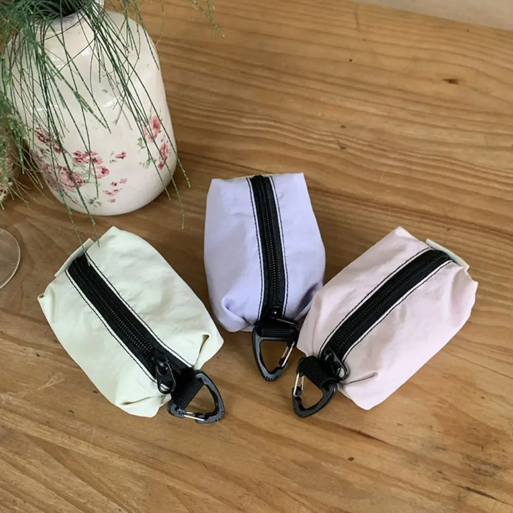 Monedero portátil de tela de nailon, estilo coreano, gran capacidad, cremallera, bolsa para artículos pequeños, bolsa de cosméticos ligera de Color sólido para auriculares