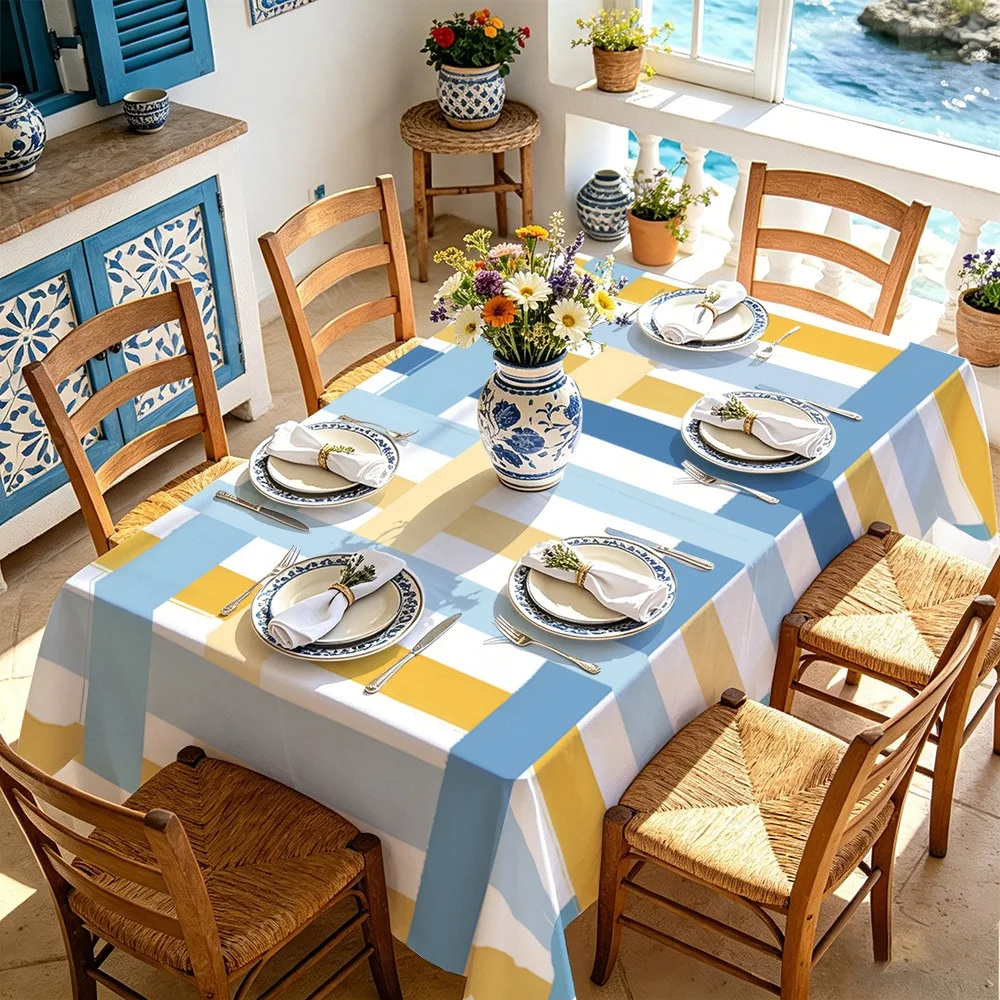 Blue, yellow and white striped tablecloth with contrasting geometric patterns design.