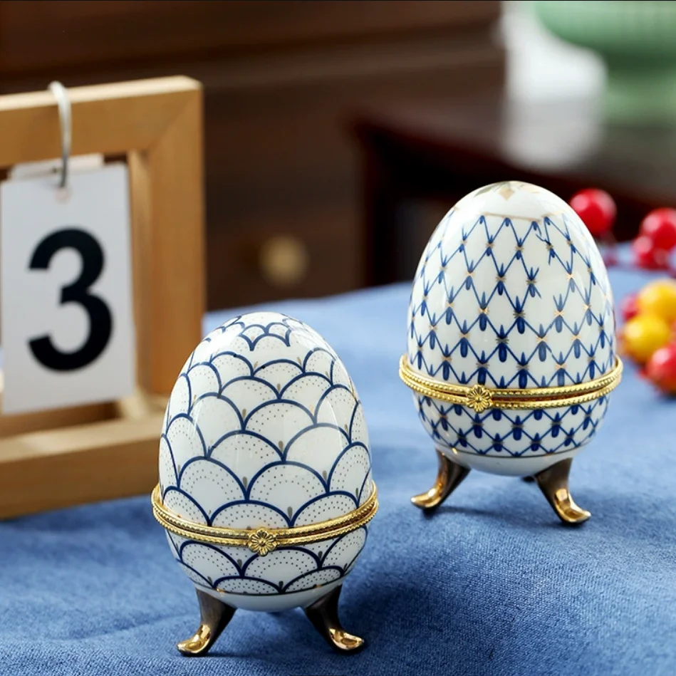 

Ceramic gold-plated three legged egg shaped ceramic jewelry box, French hand-painted gold-plated cover box, antique rack decorat