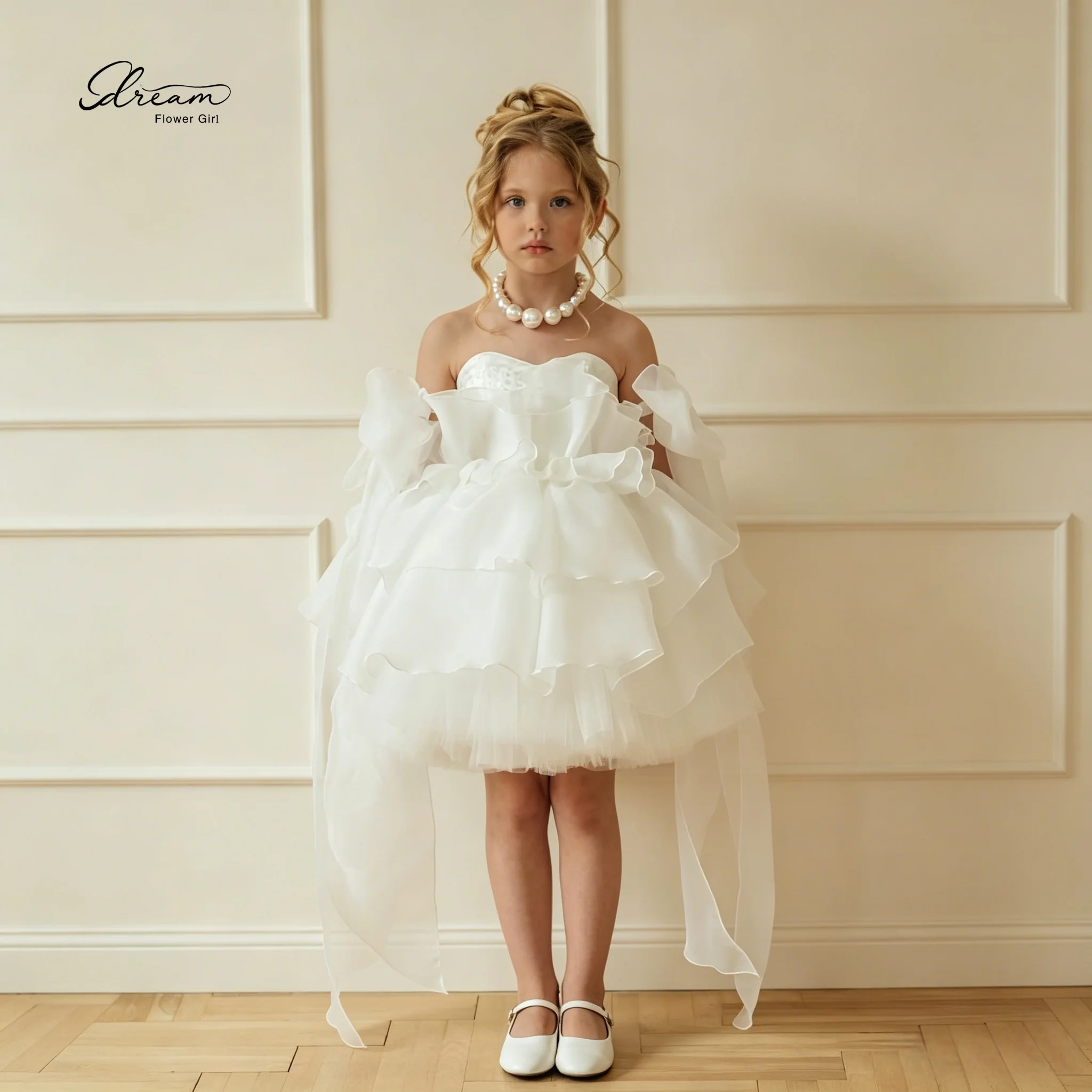 

White sleeveless knee-length princess-style formal dress for girls featuring a lace design and a full voluminous skirt