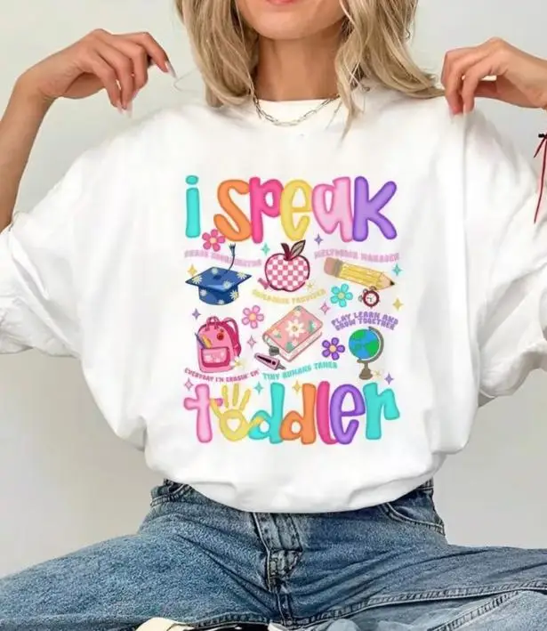 Women Childcare Provider Graphic T Shirt I Speak Toddler Colorful School Supplies Print Round Neck Short Sleeve Daycare Educator Gift Tee