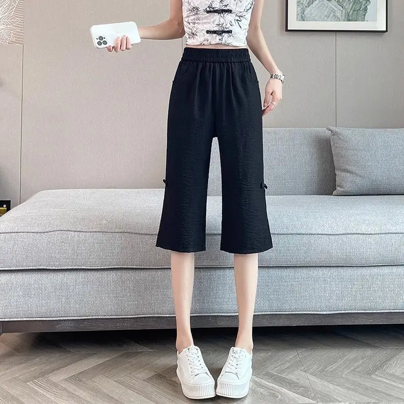 Moda Tasche impiombate elastiche Pantaloni svasati con bottoni Abbigliamento femminile 2025 Estate Nuovi pantaloni a vita alta vintage in tinta unita allentati