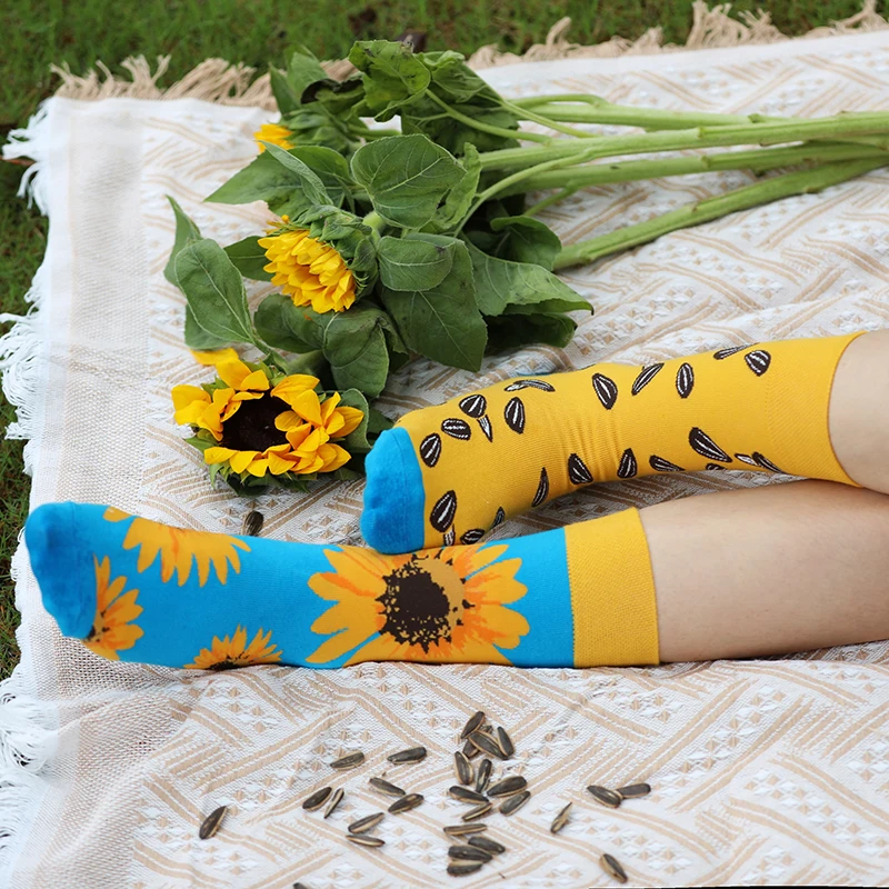 A pair of trendy socks with sunflower and melon seed patterns, asymmetrical AB style socks for men and women, suitable for every